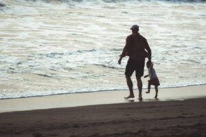father and child at beach
